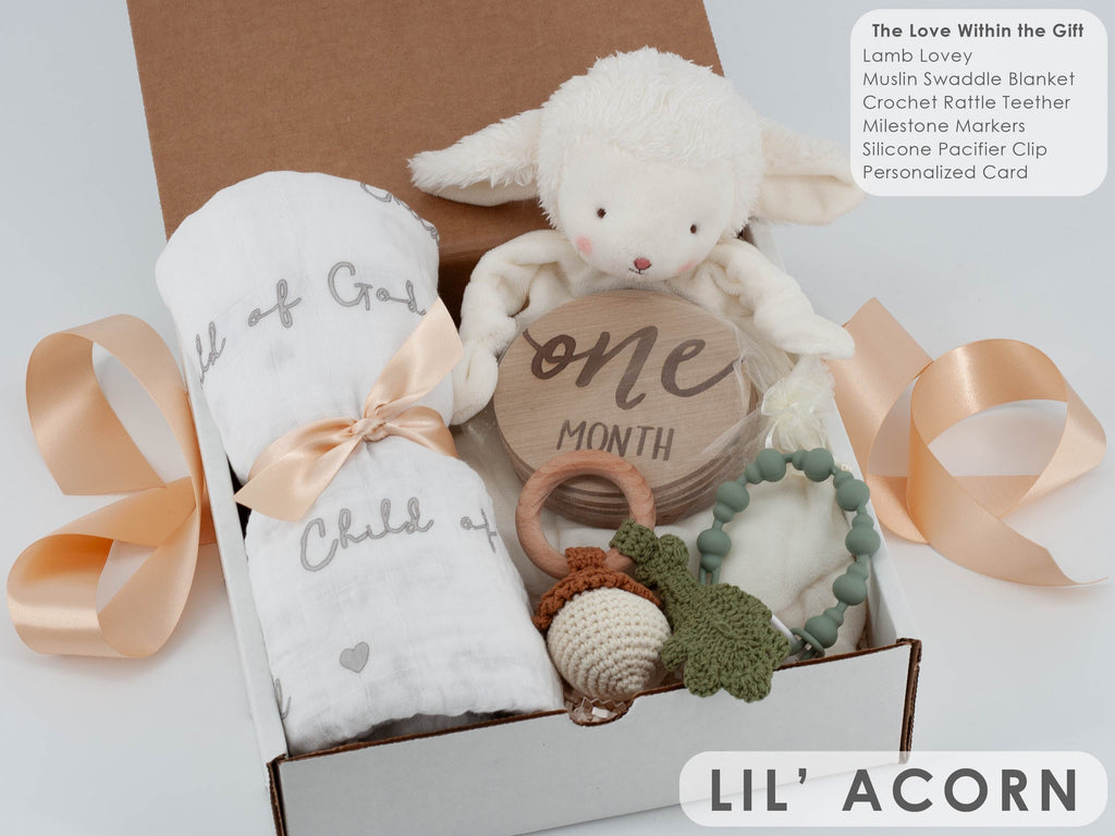 Baby gift set with plush toy, milestone card, and baby items in a box, branded 'LIL' ACORN'.